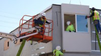 Three men working at a contruction site