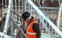 man standing under scaffoldings