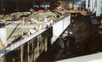 Workers apply a waterproof coating to a wall